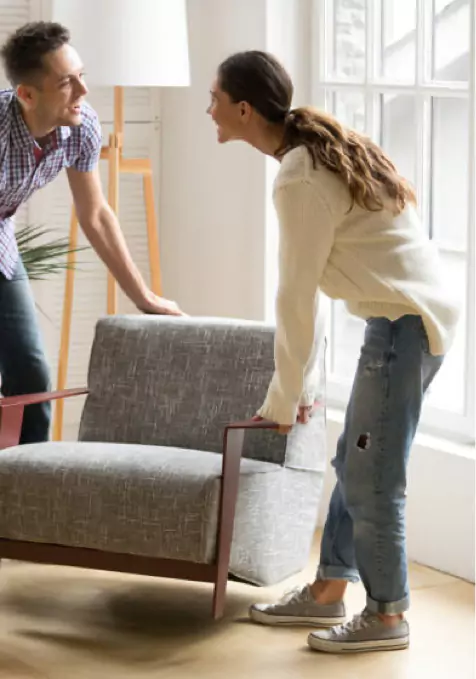 Couple moving sofa | Stevens Floor Coverings