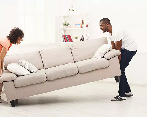 Couple moving sofa | Stevens Floor Coverings